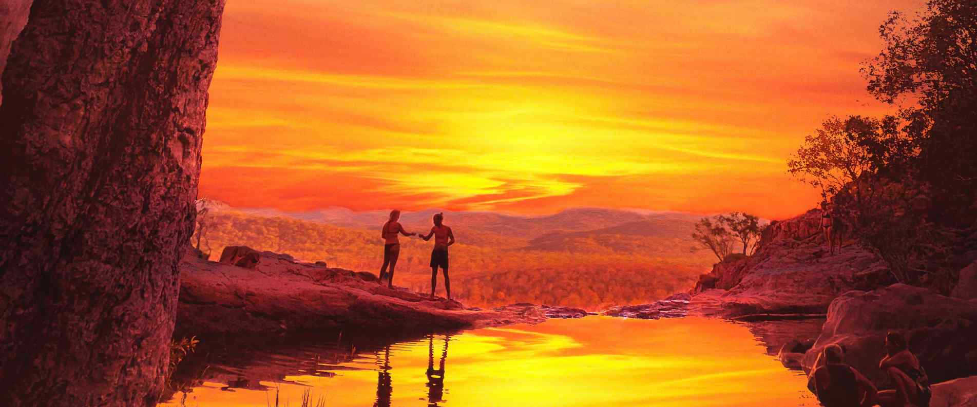people standing on edge of waterfall at sunset